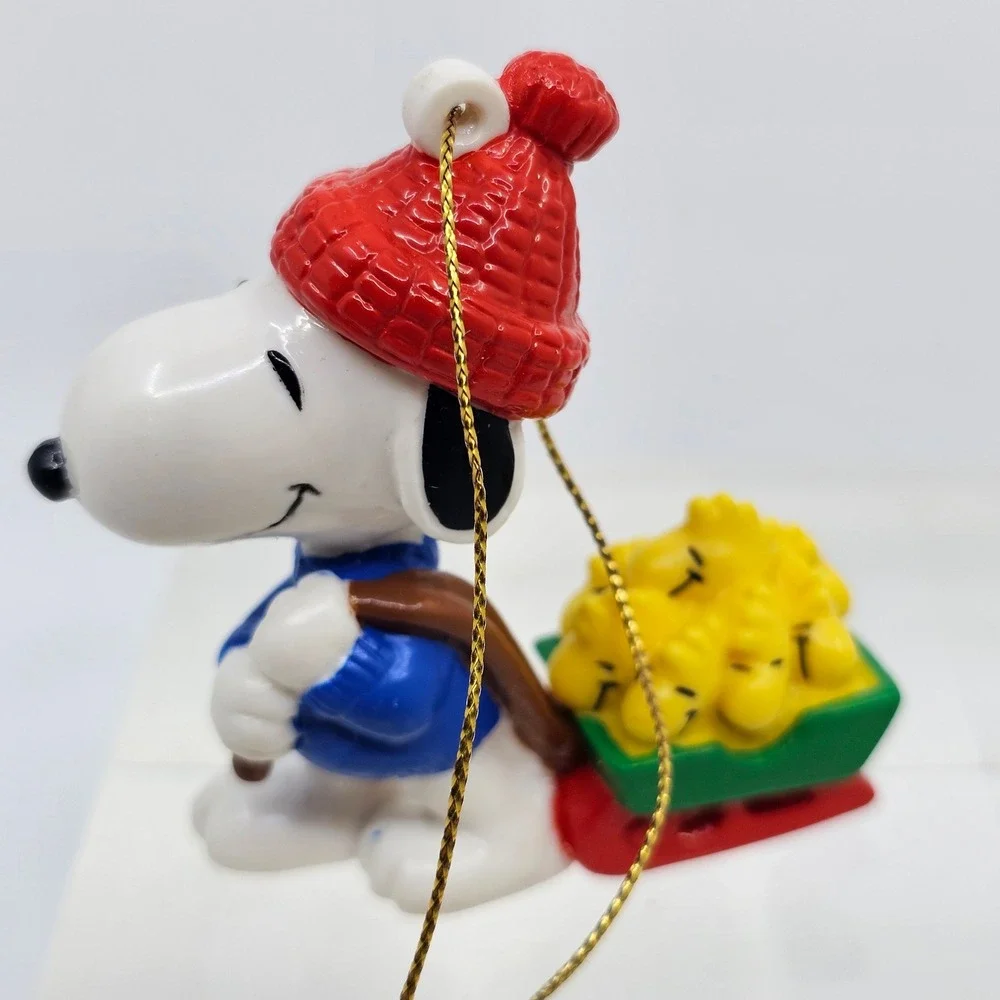 Snoopy Pulling Woodstocks Christmas Ornament. Peanuts. United Feature Syndicate